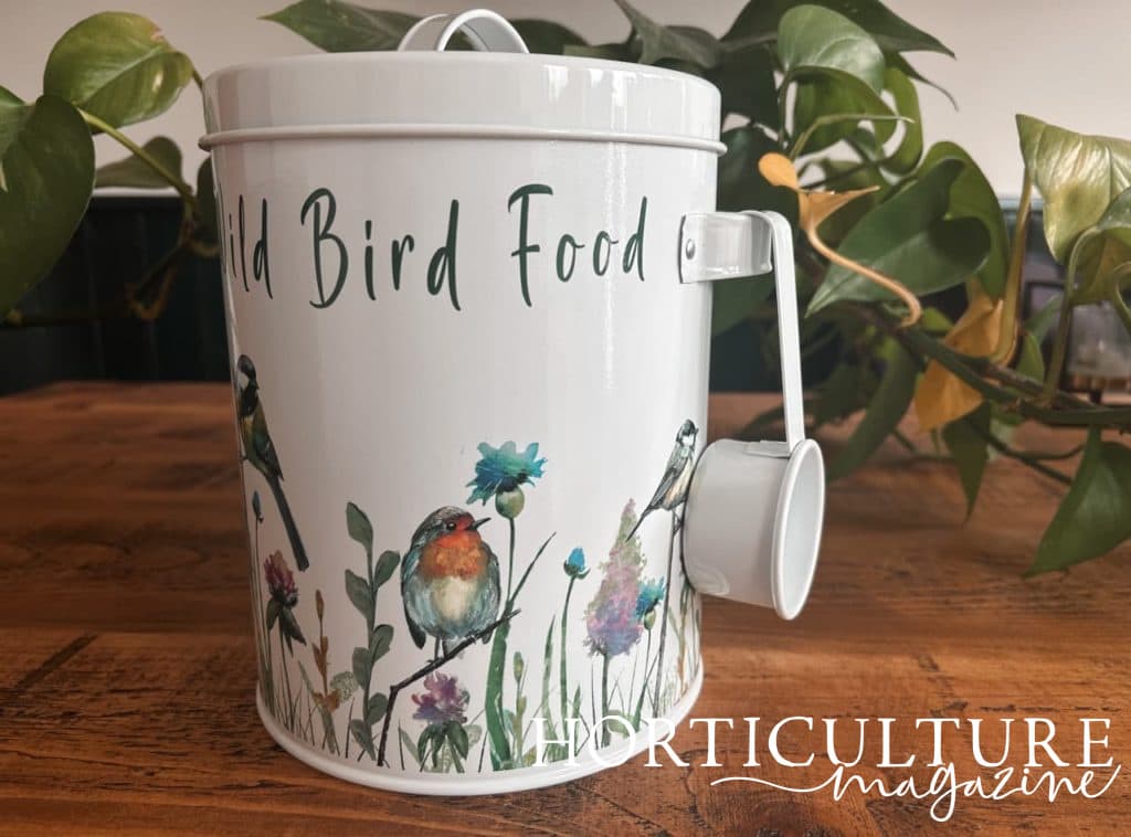 garden wild bird food tin with a scoop attached to the side