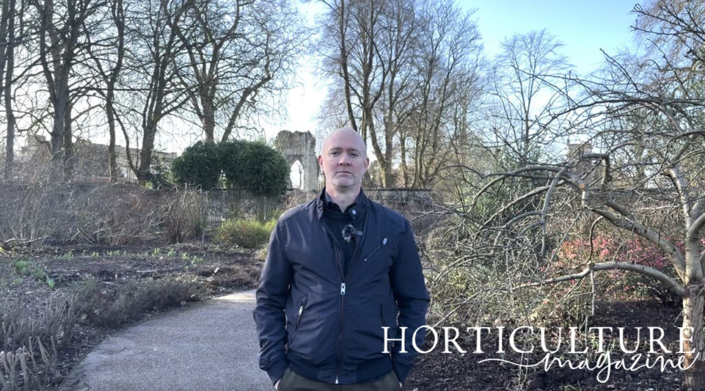 Steve Williams stood in the edible garden at the museum gardens