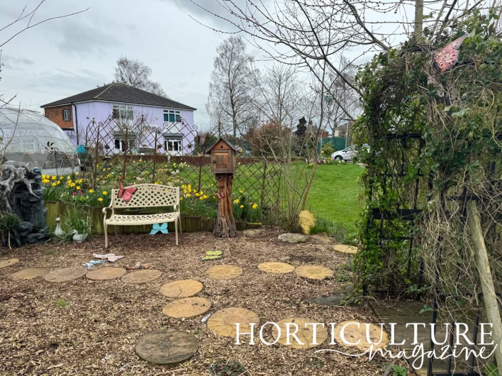 the memory garden at Oasis with a bench and lots of butterfly statues
