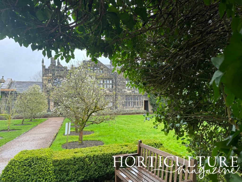 the Hall at East Riddlesden with a lawn and fruit trees in the foreground