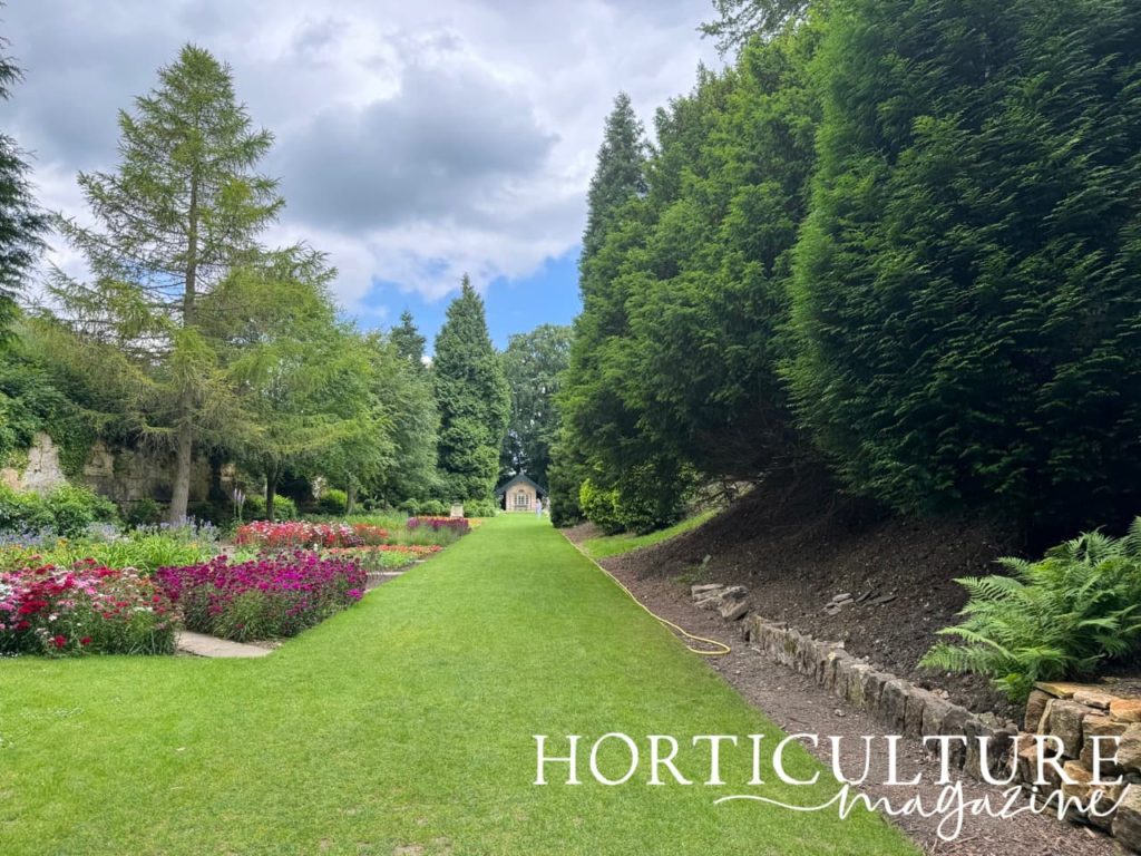 the archer house at Brodsworth with flower beds on the left hand side