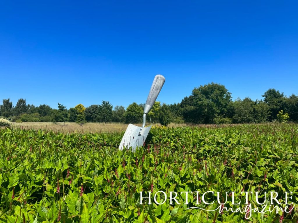 the trowel statue in the middle of the wildflower fields at Breezy Knees Gardens